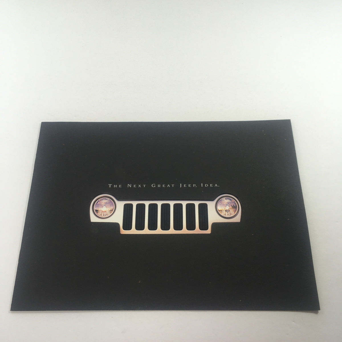 Cover image of the 2002 Jeep Liberty Dealership Car Auto Brochure Catalog featuring the iconic Jeep grille and headlights against a black background.