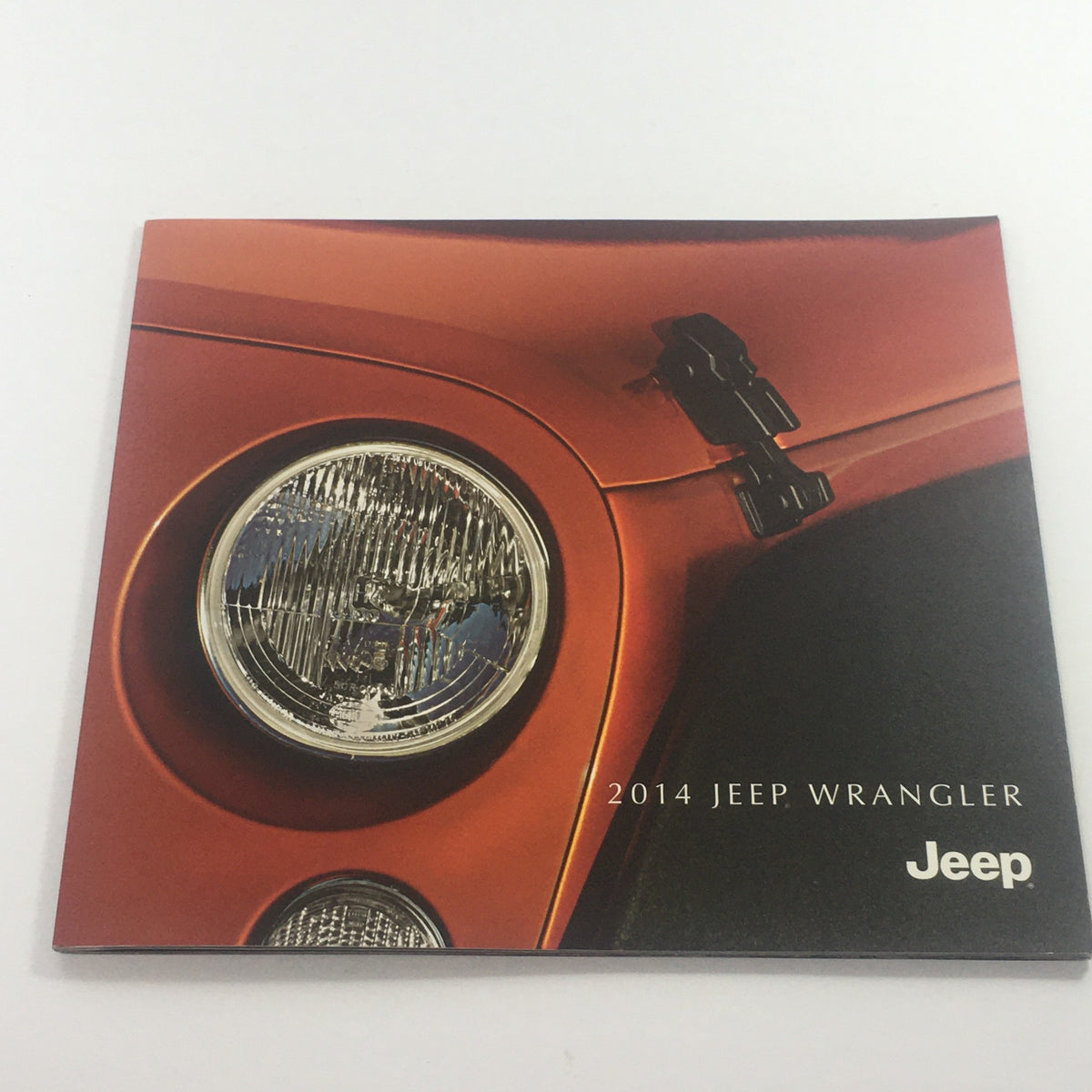 Cover of the 2014 Jeep Wrangler 4x4 Dealership Car Auto Brochure Catalog featuring the iconic Jeep logo and a close-up of the headlight.