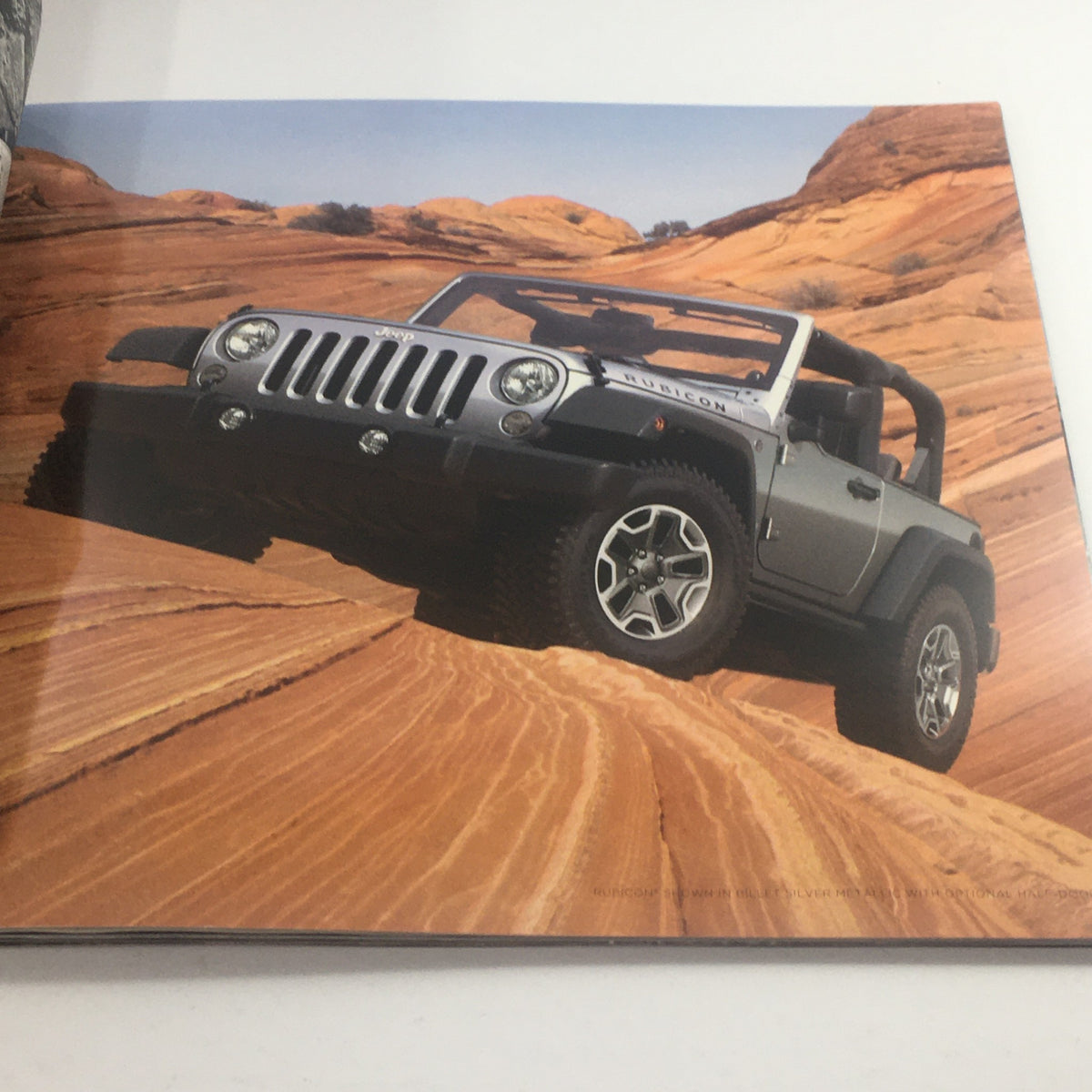 Inside page of the 2014 Jeep Wrangler 4x4 Dealership Car Auto Brochure showcasing a Jeep Wrangler Rubicon model against a desert backdrop.