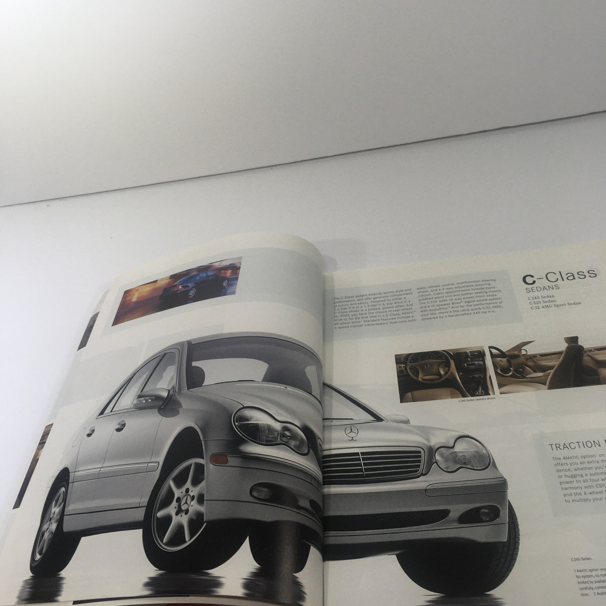 Open page of the 2003 Mercedes-Benz C-Class, SLK-Class Dealership Car Auto Brochure Catalog displaying the c-Class sedan along with interior features.
