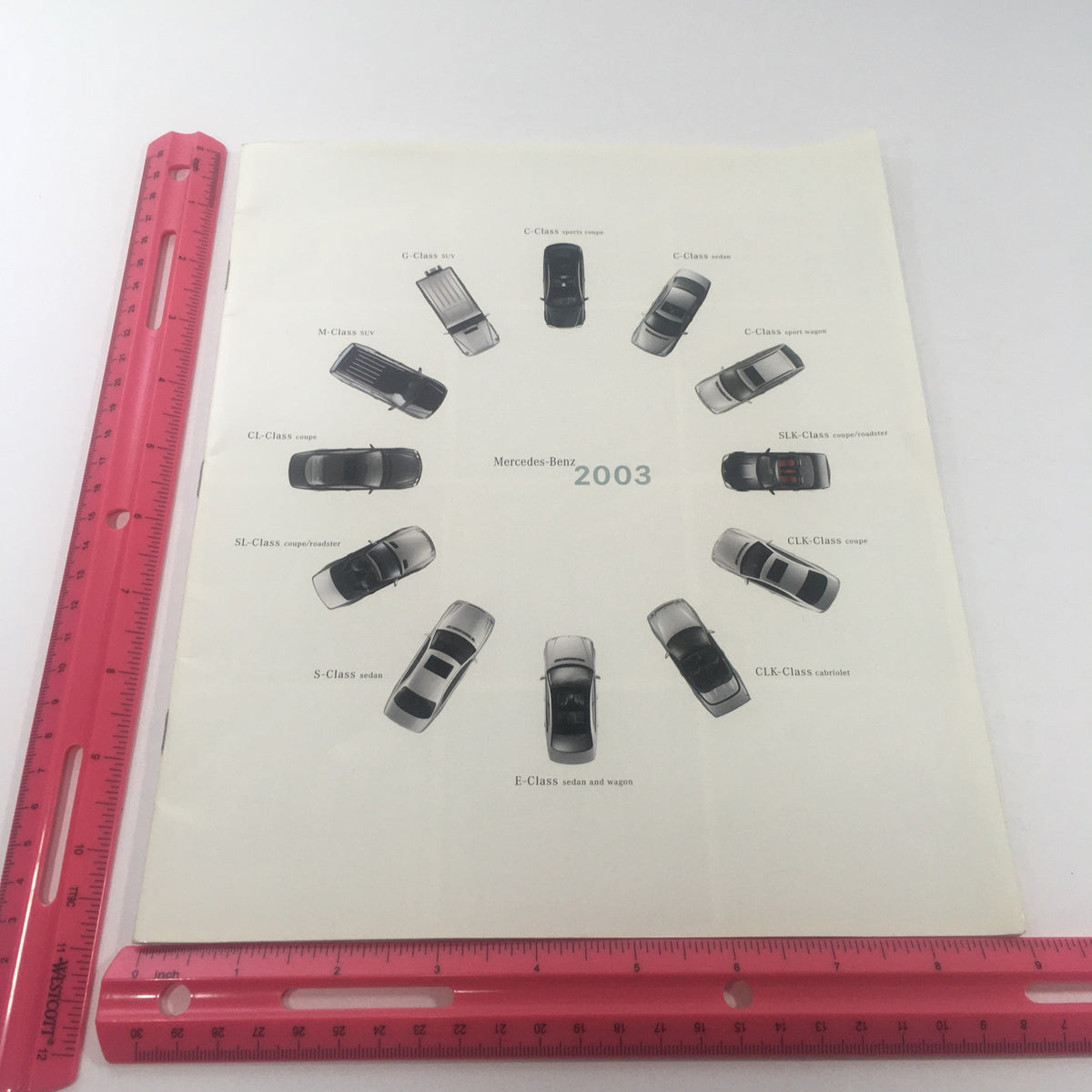2003 Mercedes-Benz C-Class, SLK-Class Dealership Car Auto Brochure Catalog featuring a display of various Mercedes-Benz models arranged in a circular pattern with labels for each model, indicating the brand's 2003 lineup.