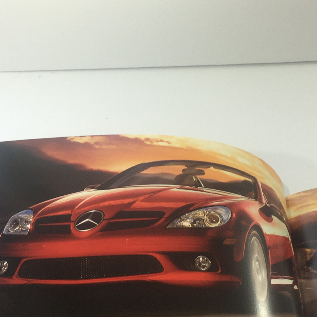 2008 Mercedes-Benz SLK-Class 280-350-55-AMG dealership car brochure featuring a striking red convertible sports car against a sunset backdrop.