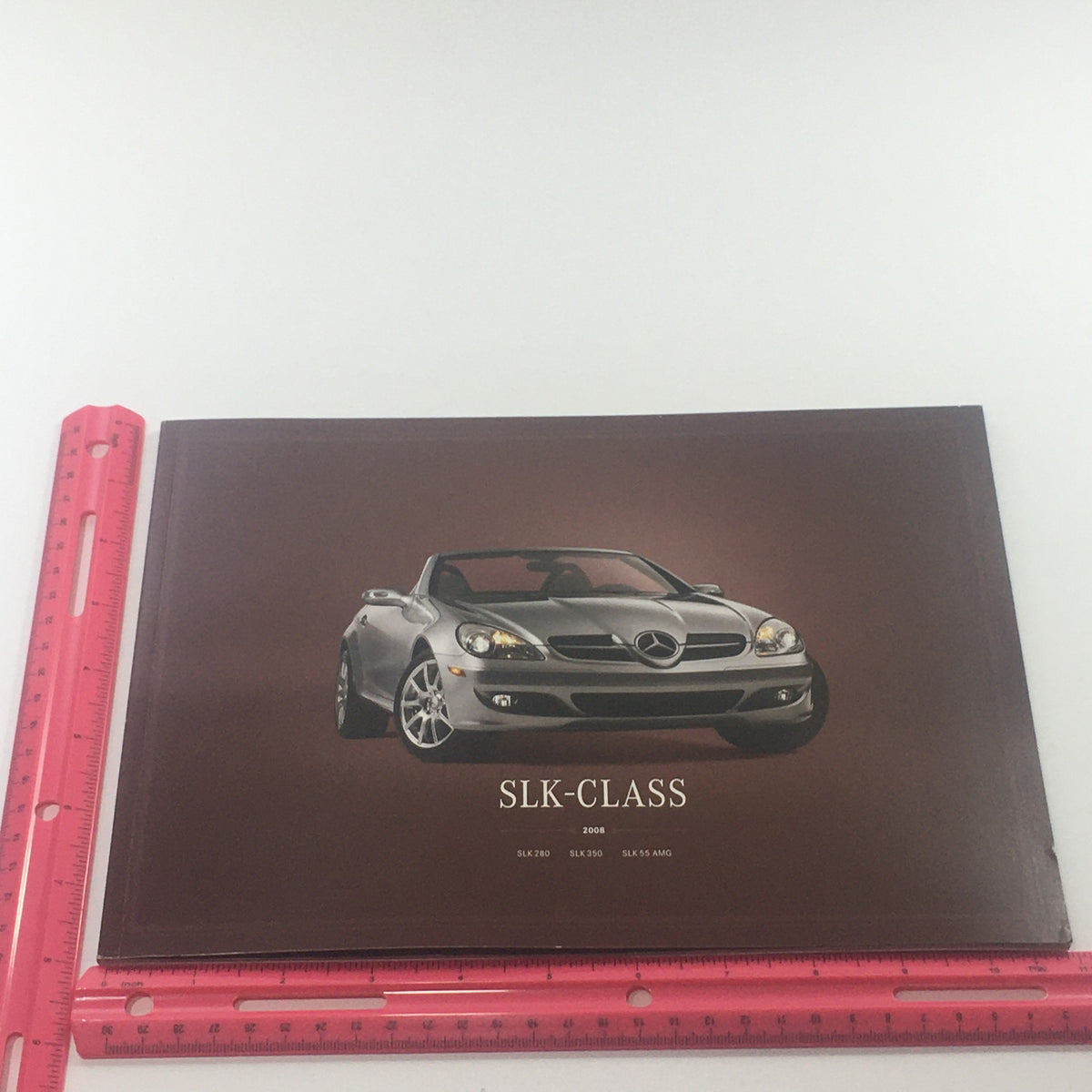 Front cover of the 2008 Mercedes-Benz SLK-Class 280-350-55-AMG dealership car brochure with an image of a stylish silver convertible over a brown background.