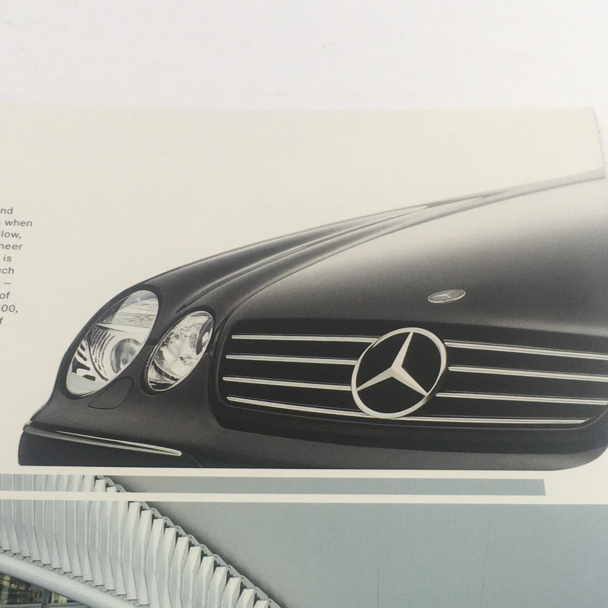 Close-up view of the front grille and headlights of a 2005 Mercedes-Benz CL-Class 500-55-AMG-600, showcasing its sleek design in the dealership car auto brochure catalog.