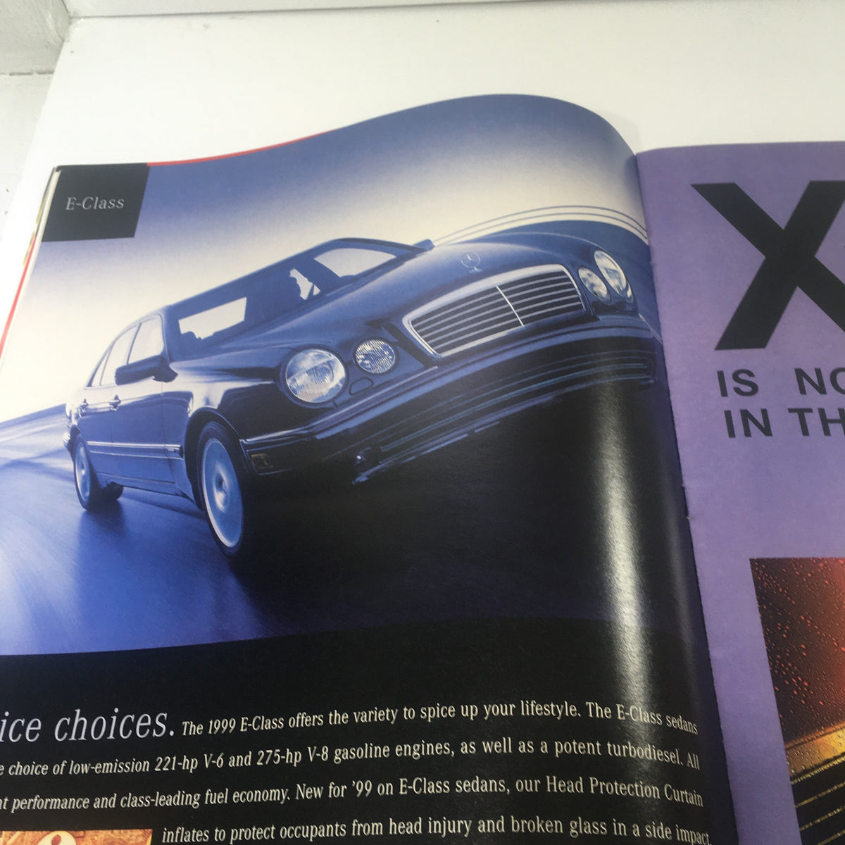 1999 Mercedes-Benz E-Class Dealership Car Auto Brochure Catalog showcasing the sleek design of the Mercedes-Benz E-Class in a dynamic driving scenario.