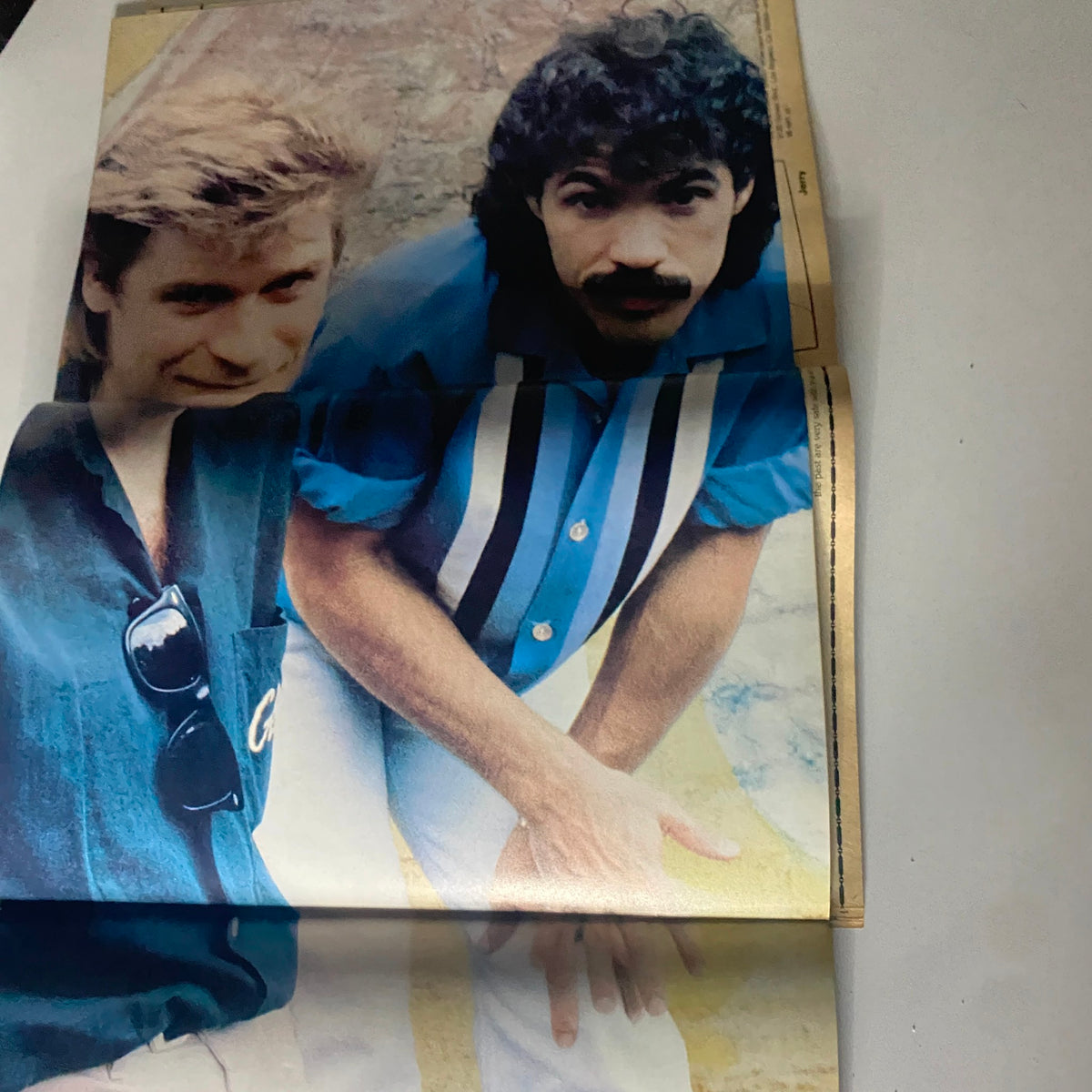 Vintage photograph of Hall & Oates from 16 Magazine April 1982, showcasing the iconic duo in colorful outfits.