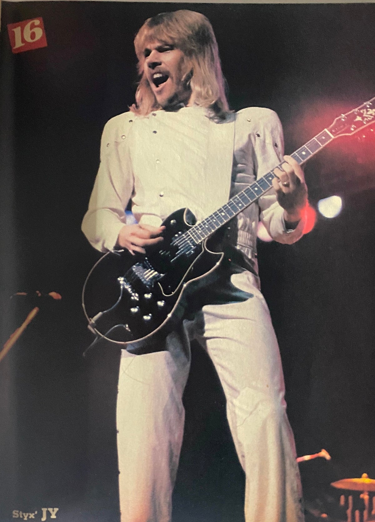 Styx's J.Y. Young performing on stage, featured in 16 Magazine April 1982, capturing the vibrant music scene of the 1980s.
