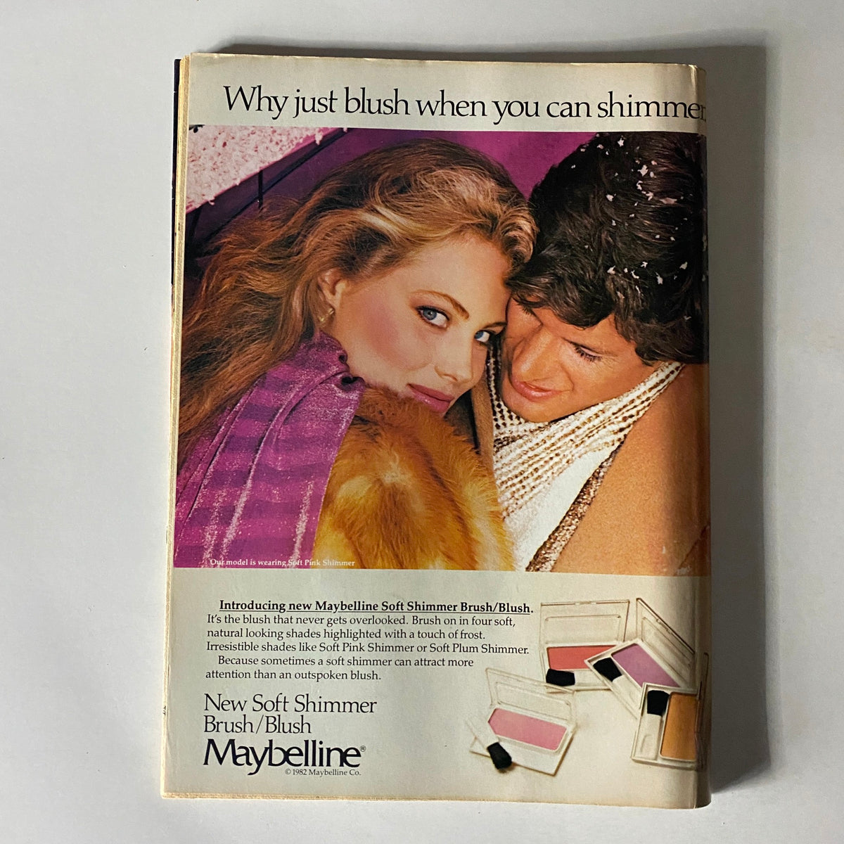 Maybelline advertisement featuring a glamorous model with a male counterpart in the 16 Magazine April 1982, showcasing beauty trends of the decade.