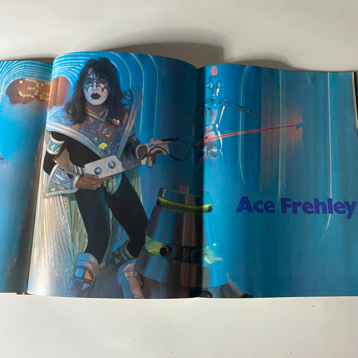 Ace Frehley featured in the January 1981 issue of 16 Magazine, showcasing his iconic glam rock style with a guitar in a vibrant setting.