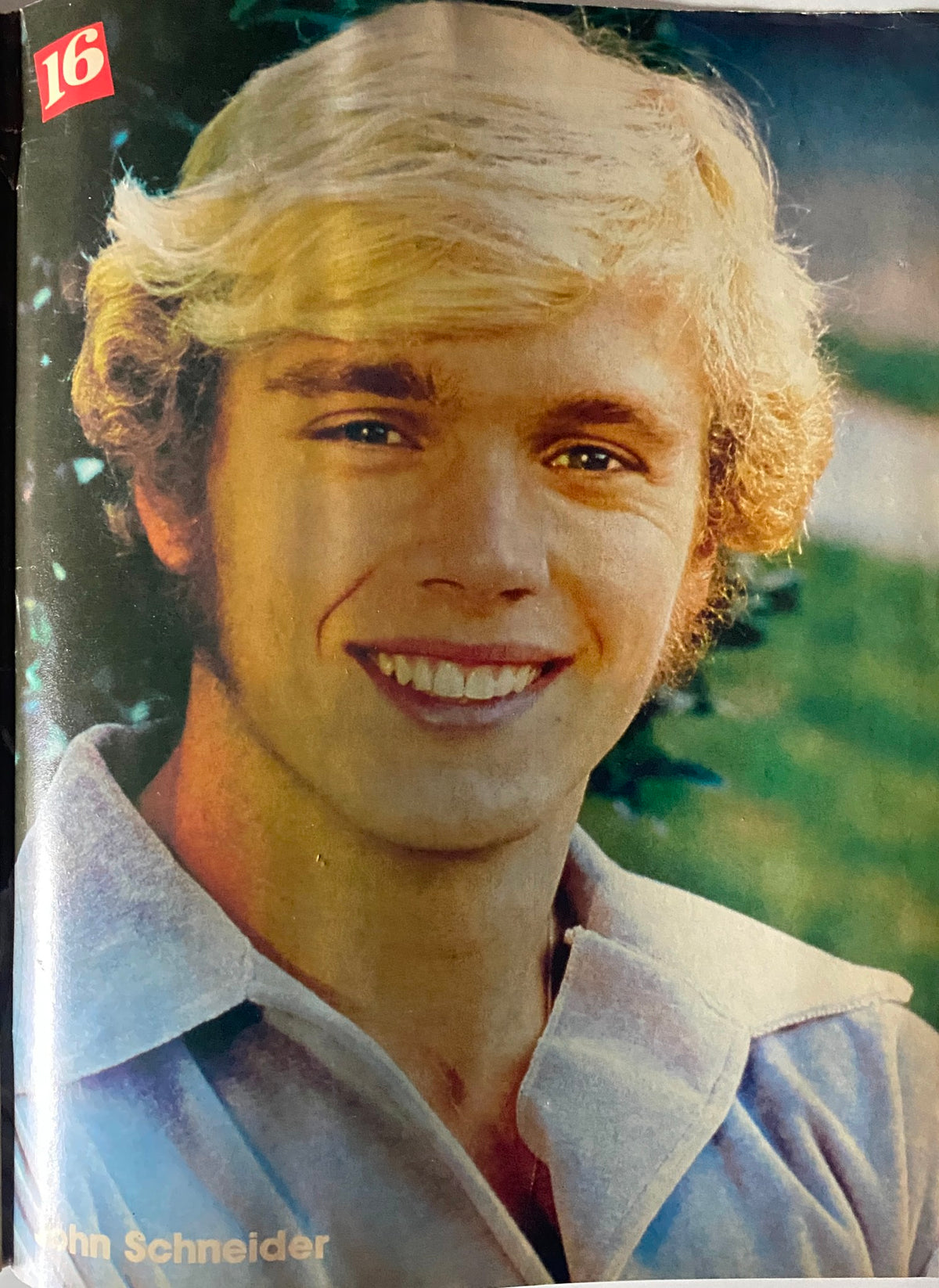 John Schneider featured in the January 1981 issue of 16 Magazine, displaying a bright smile and retro hairstyle, capturing the essence of the early '80s pop culture.