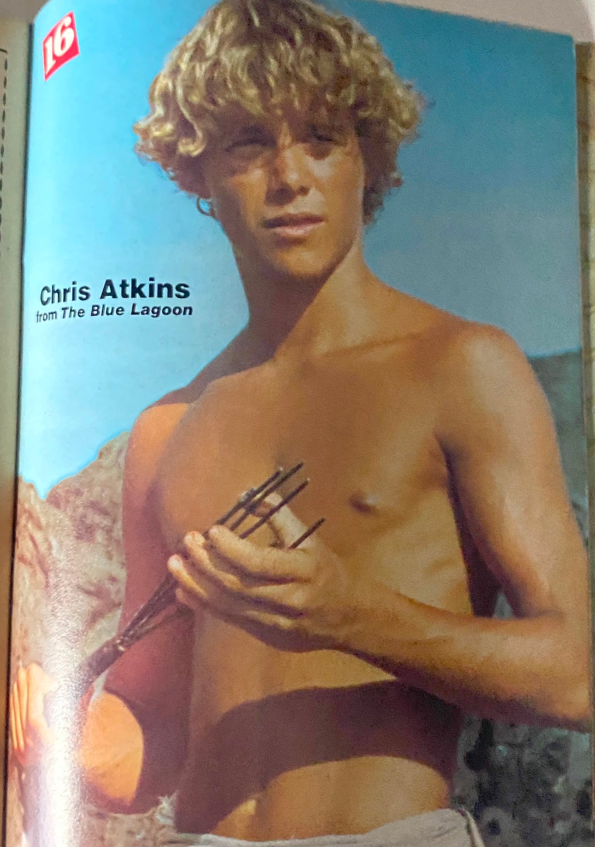 16 Magazine December 1980 featuring Chris Atkins from The Blue Lagoon, showcasing a young model with curly hair holding fishing spears, capturing the essence of early 80s pop culture.
