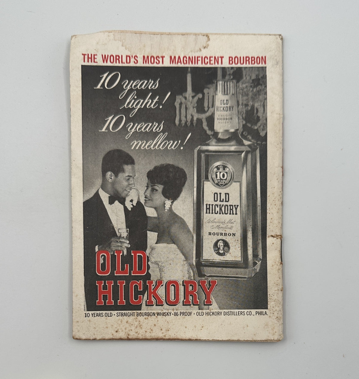 Advertisement for Old Hickory bourbon, showcasing its features with a couple enjoying a drink, from a vintage publication.