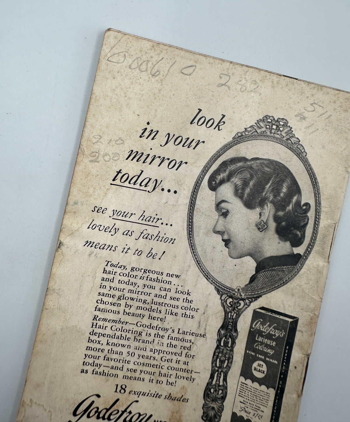 Advertisement in Jet Magazine August 22, 1957 for Godfrey's Hair Color showcasing a woman admiring her hairstyle in a mirror, highlighting beauty and fashion.