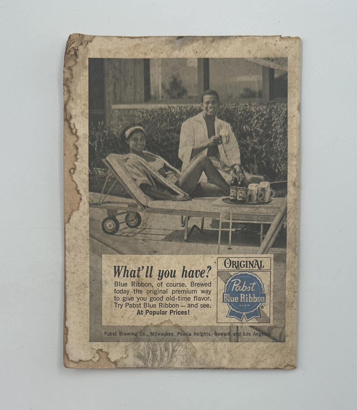 Vintage advertisement from Jet Magazine July 22, 1965 featuring a relaxation scene with a man and a woman. The ad promotes Pabst Blue Ribbon beer, highlighting the phrase 'What’ll you have? Blue Ribbon, of course.' Captures 1960s leisure culture and beverages.