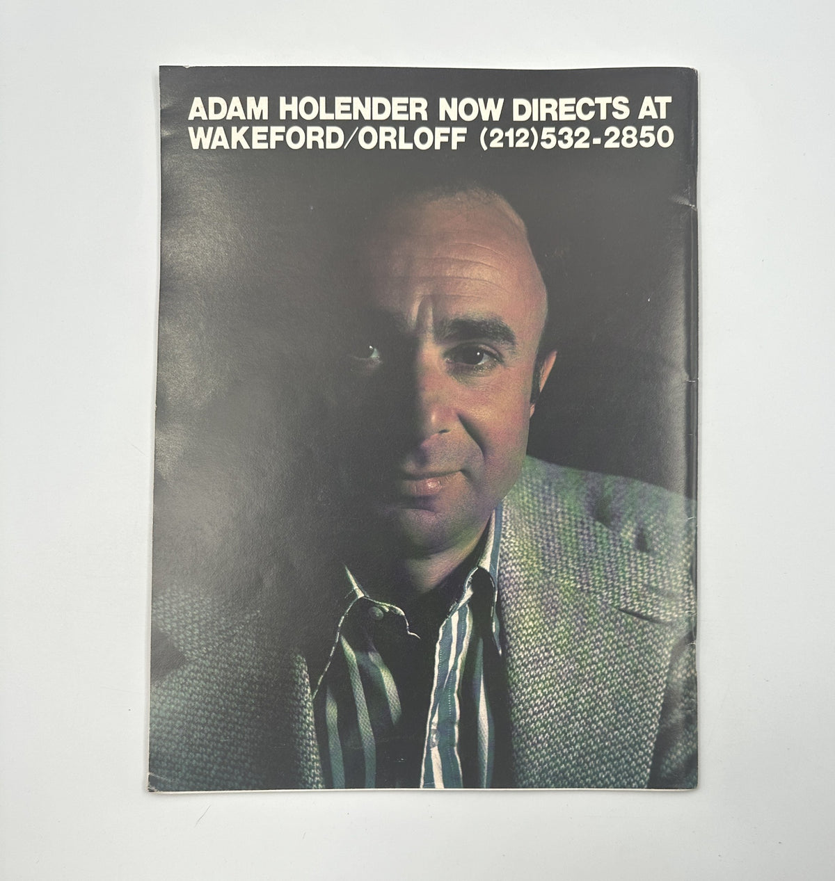 Advertisement in Millimeter Magazine July-August 1976 for Adam Holender, a director, set against a dark background focusing on his professional profile.