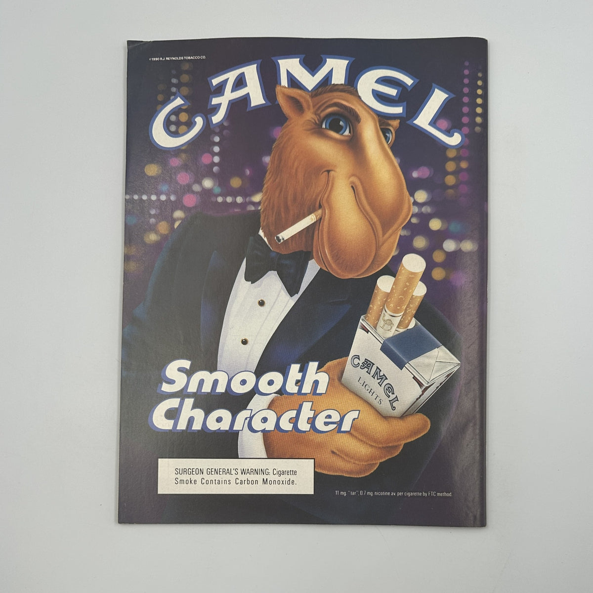 Vintage advertising image of a cartoon camel character promoting Camel cigarettes with the slogan 'Smooth Character', showcasing a sophisticated design that reflects the brand's marketing style during the 1990s.