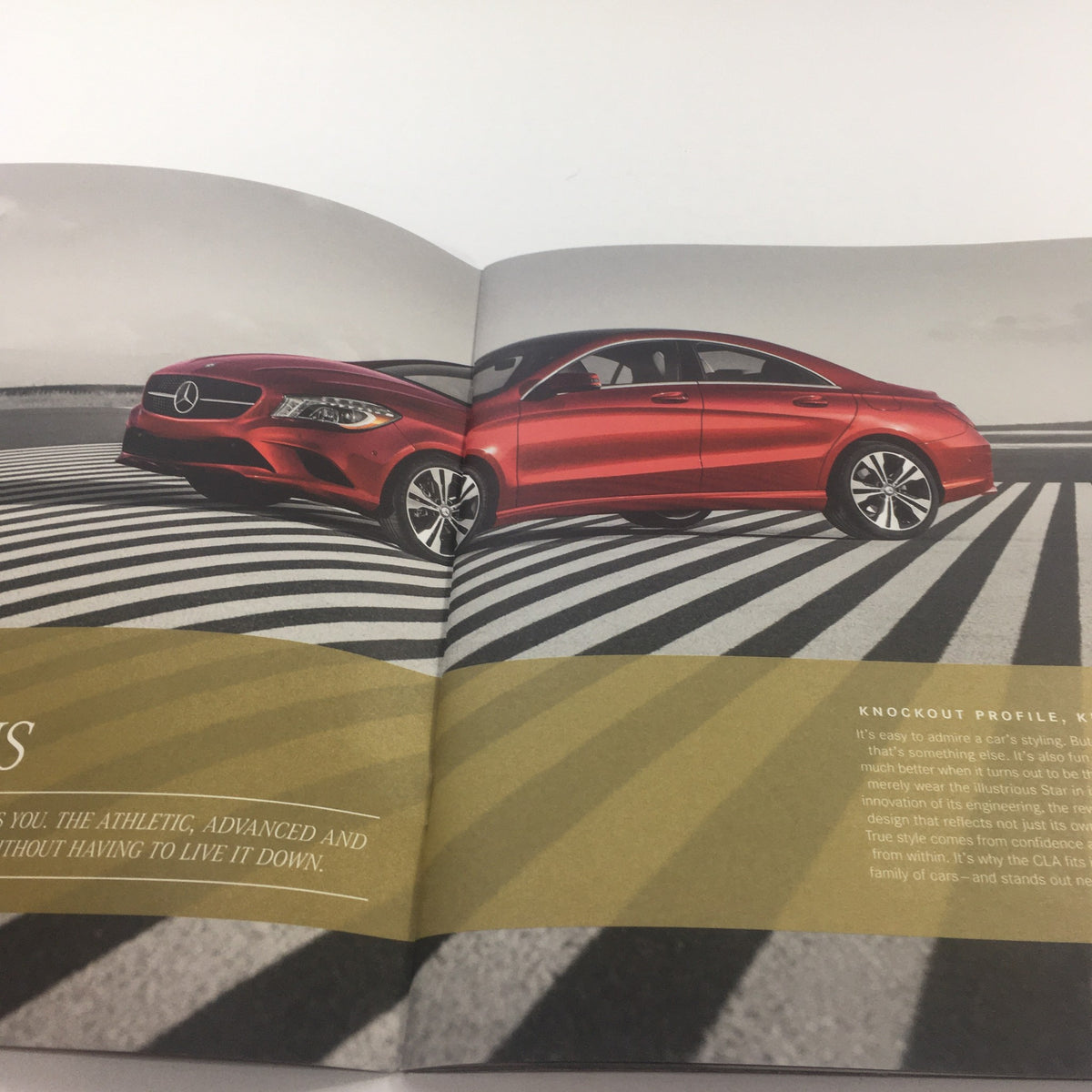 Inside view of the 2016 Mercedes-Benz CLA Dealership Car Auto Brochure showcasing a red CLA car against a modern striped road design.