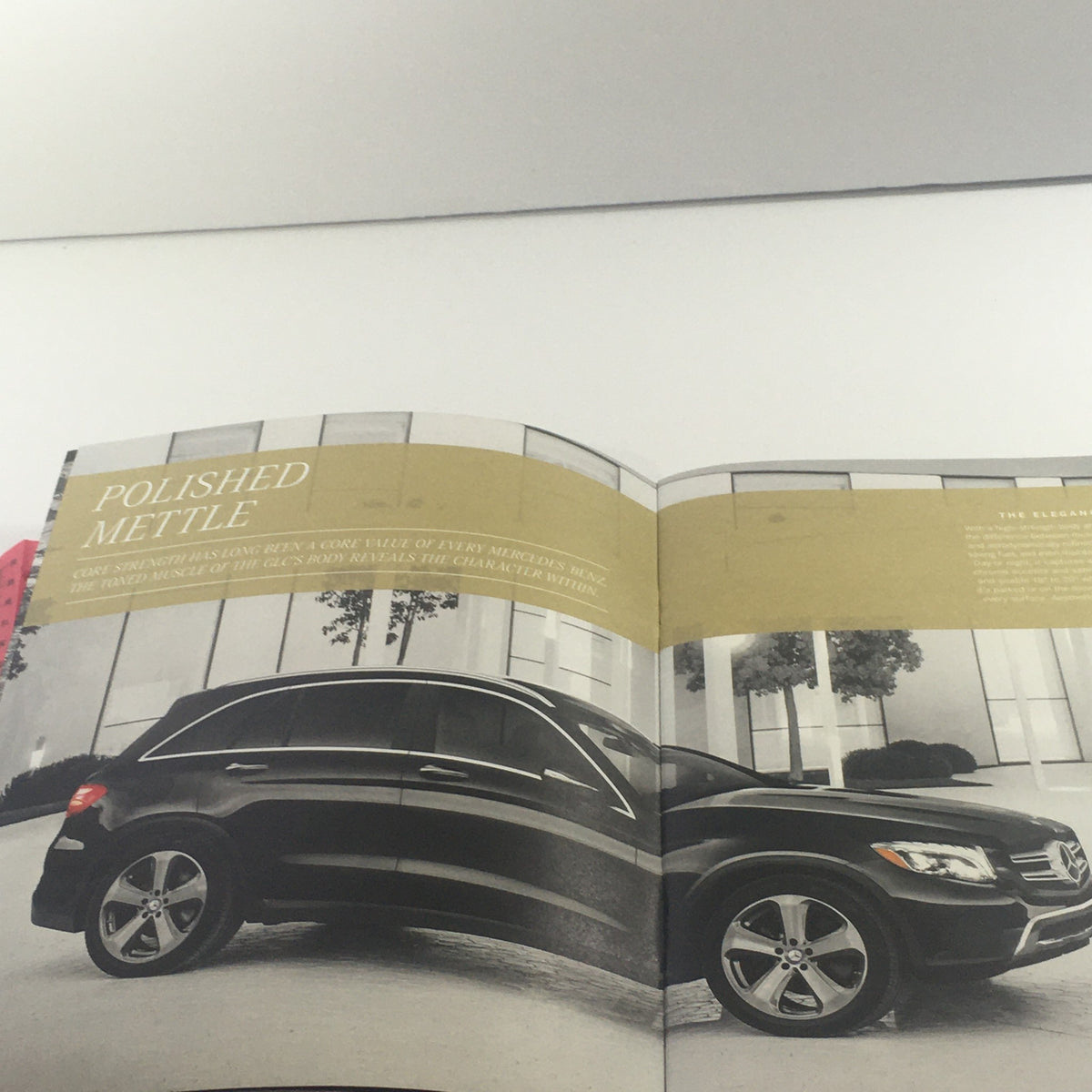 Interior page of the 2016 Mercedes-Benz GLC-Class Polished Mettle Dealership Auto Brochure Catalog featuring the vehicle in a stylish urban setting.