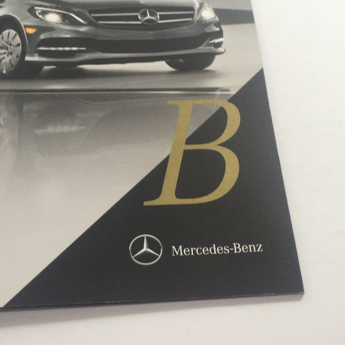Close-up of the 2016 Mercedes-Benz B-Class Electric Drive Auto Brochure, highlighting the bold letter 'B' and the Mercedes-Benz logo.