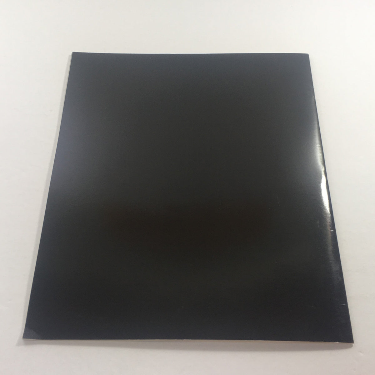 Back cover of the 1983 Mercedes Volume XI Dealership Car Auto Brochure Catalog featuring a smooth black finish.