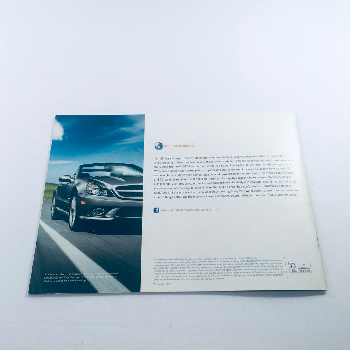 Back cover of the 2012 Mercedes-Benz SL-Class Dealership Car Auto Brochure Catalog showcasing a stylish black convertible car with a scenic road.