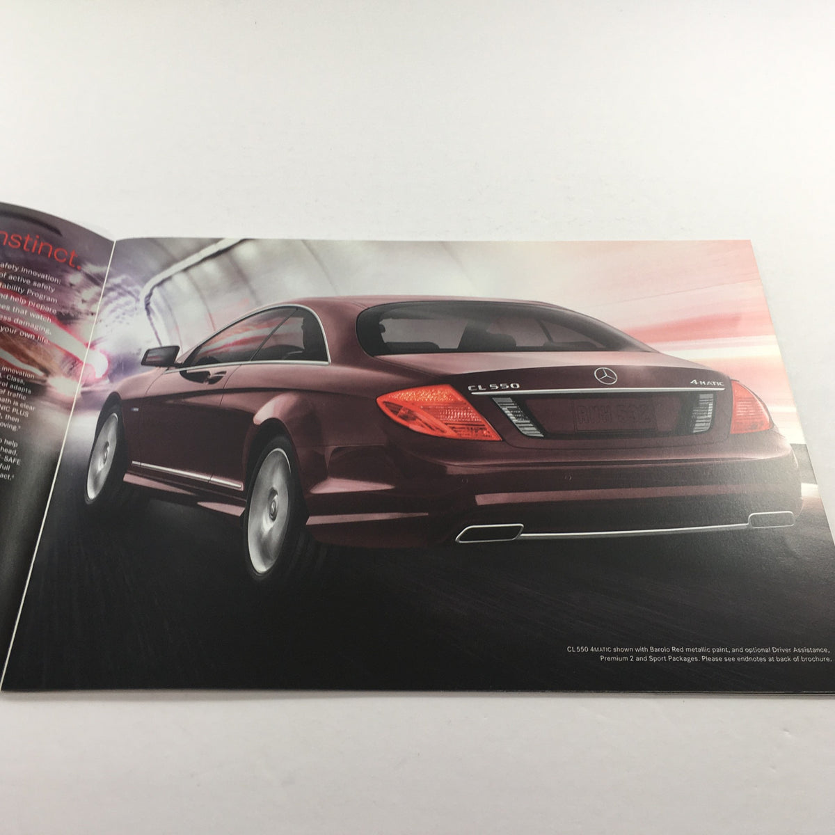 Inside page of the 2012 Mercedes-Benz CL-Class CL550 brochure featuring the rear view of the maroon coupe with sleek lines.