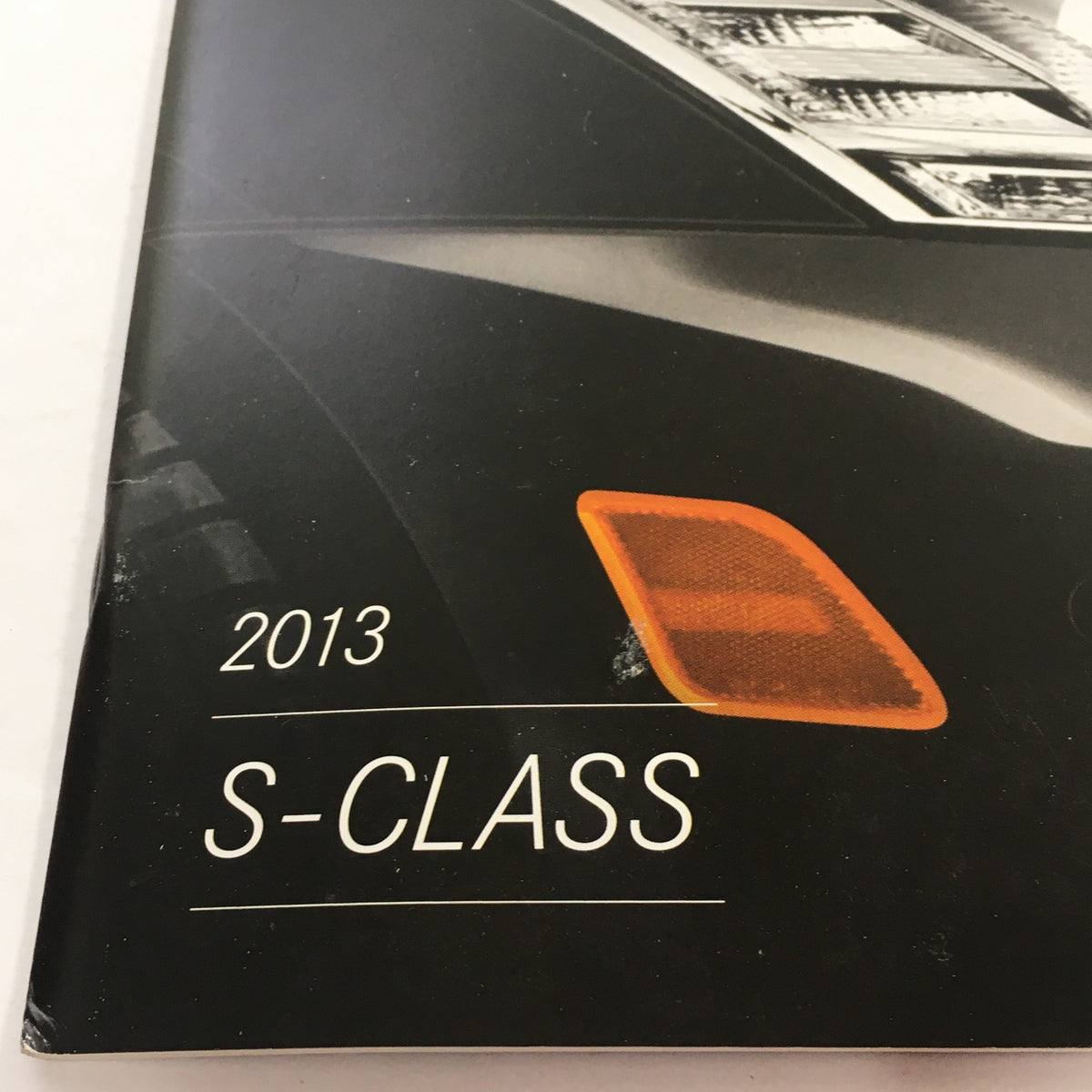 Close-up view of the 2013 Mercedes-Benz S-Class Dealership Car Auto Brochure Catalog highlighting the stylish details of the car's front corner indicator.