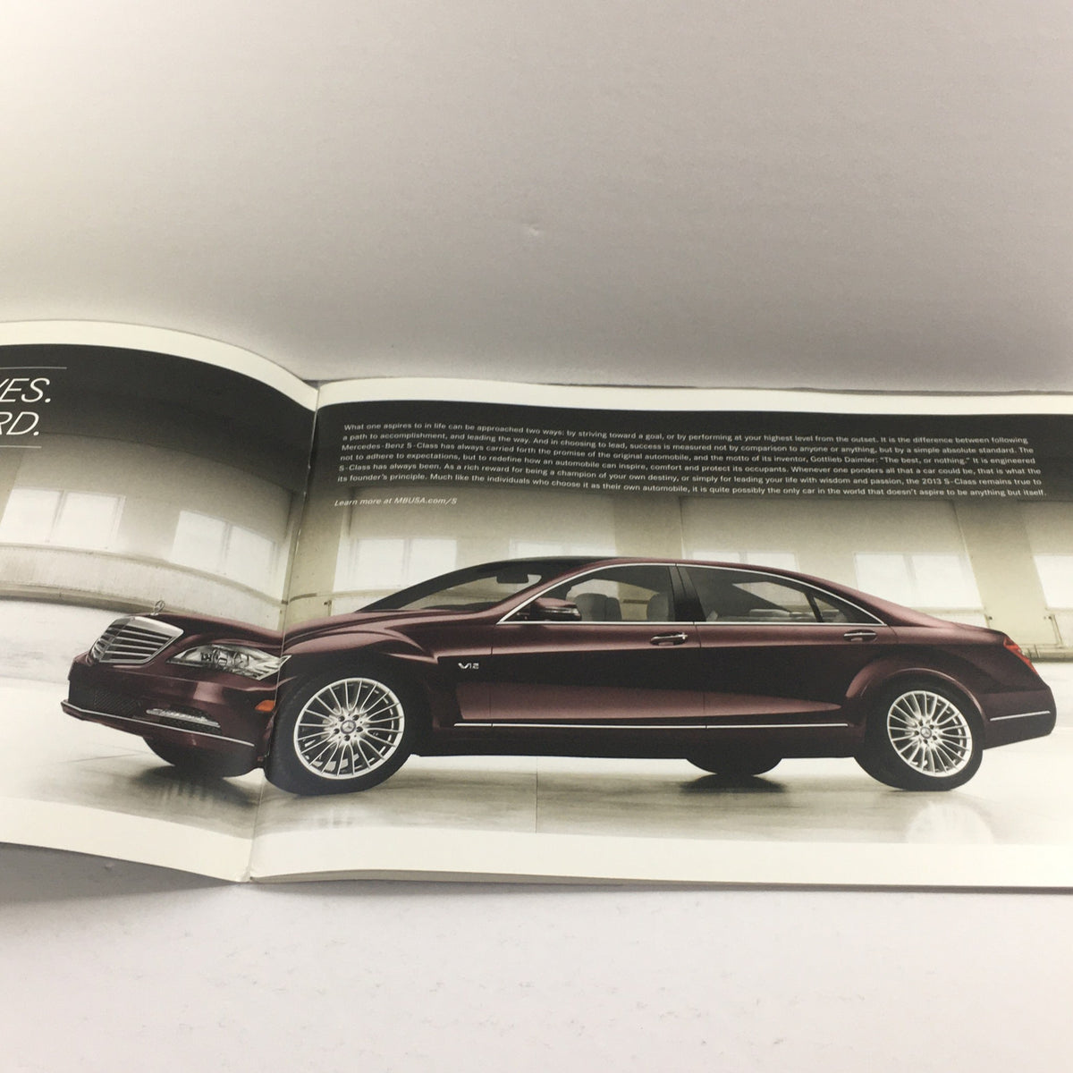 Interior page of the 2013 Mercedes-Benz S-Class Dealership Car Auto Brochure Catalog featuring a side view of the luxury vehicle displayed in an elegant setting.