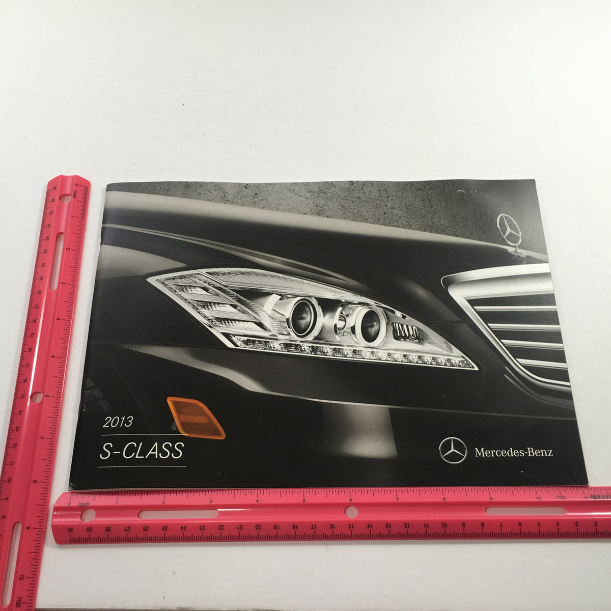 2013 Mercedes-Benz S-Class Dealership Car Auto Brochure Catalog featuring a close-up of the car's headlight design, showcasing luxury and sophistication in automotive brochures.