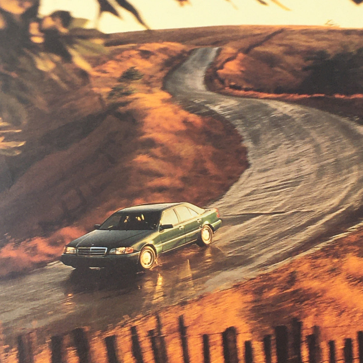 1995 Mercedes-Benz C-Class Sedan Auto Brochure depicting the car navigating a winding road, showcasing performance in a scenic landscape.