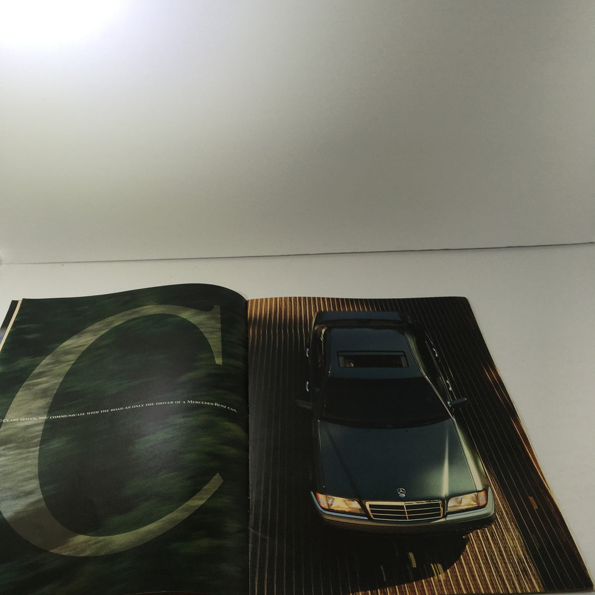 1995 Mercedes-Benz C-Class Sedan catalog image displaying the car from above with a stylish design, emphasizing its luxurious features.