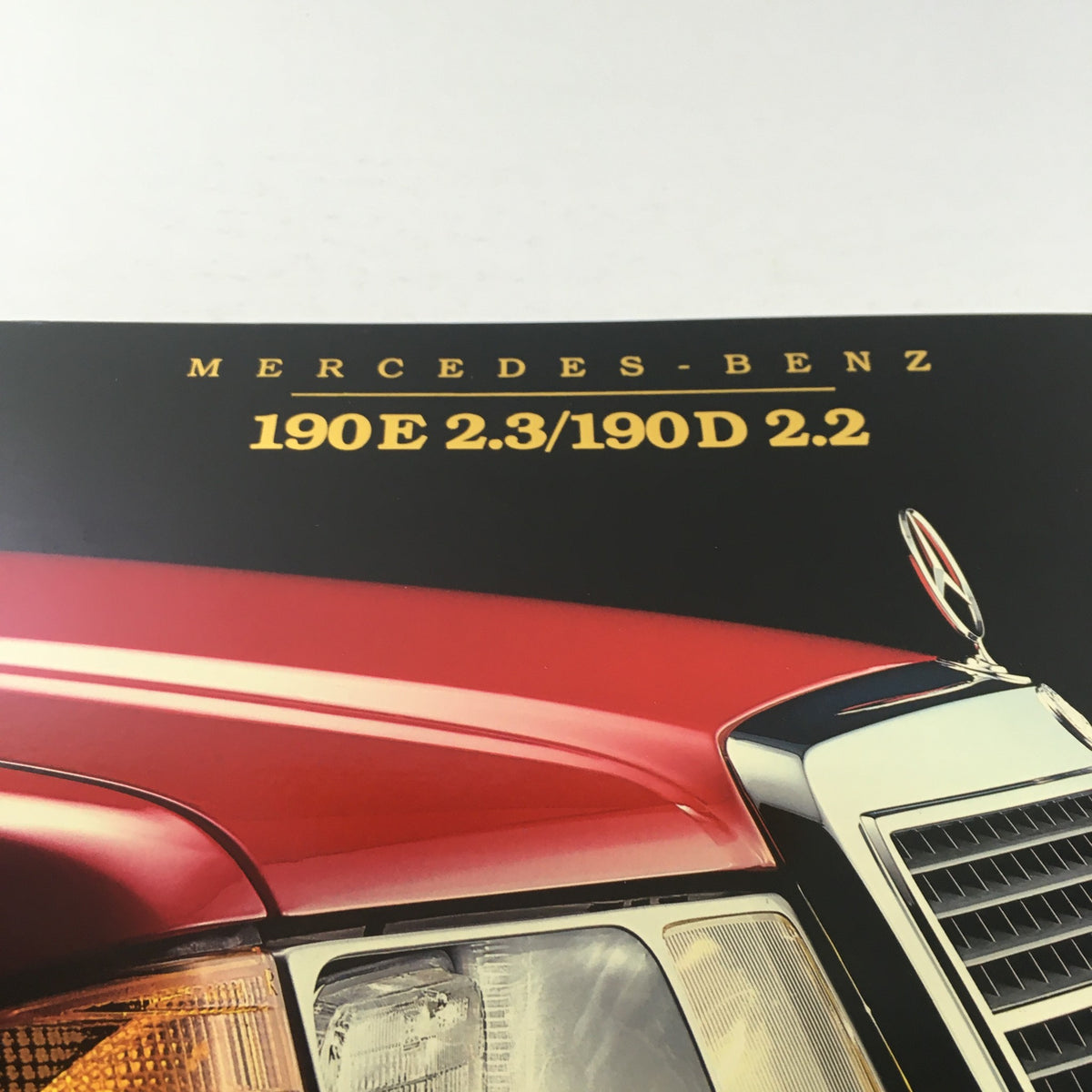 Close-up of the title on the 1984 Mercedes-Benz 190E 2.3/190D 2.2 Dealership Car Auto Brochure, highlighting the model name.
