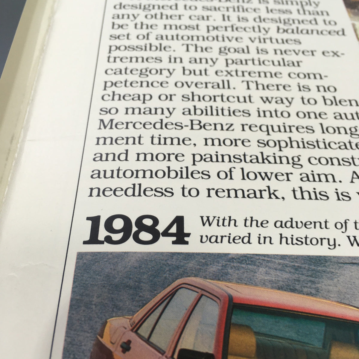 Close-up of the 1984 Mercedes-Benz 190E 2.3/190D 2.2 Dealership Car Auto Brochure showcasing historical context and text.