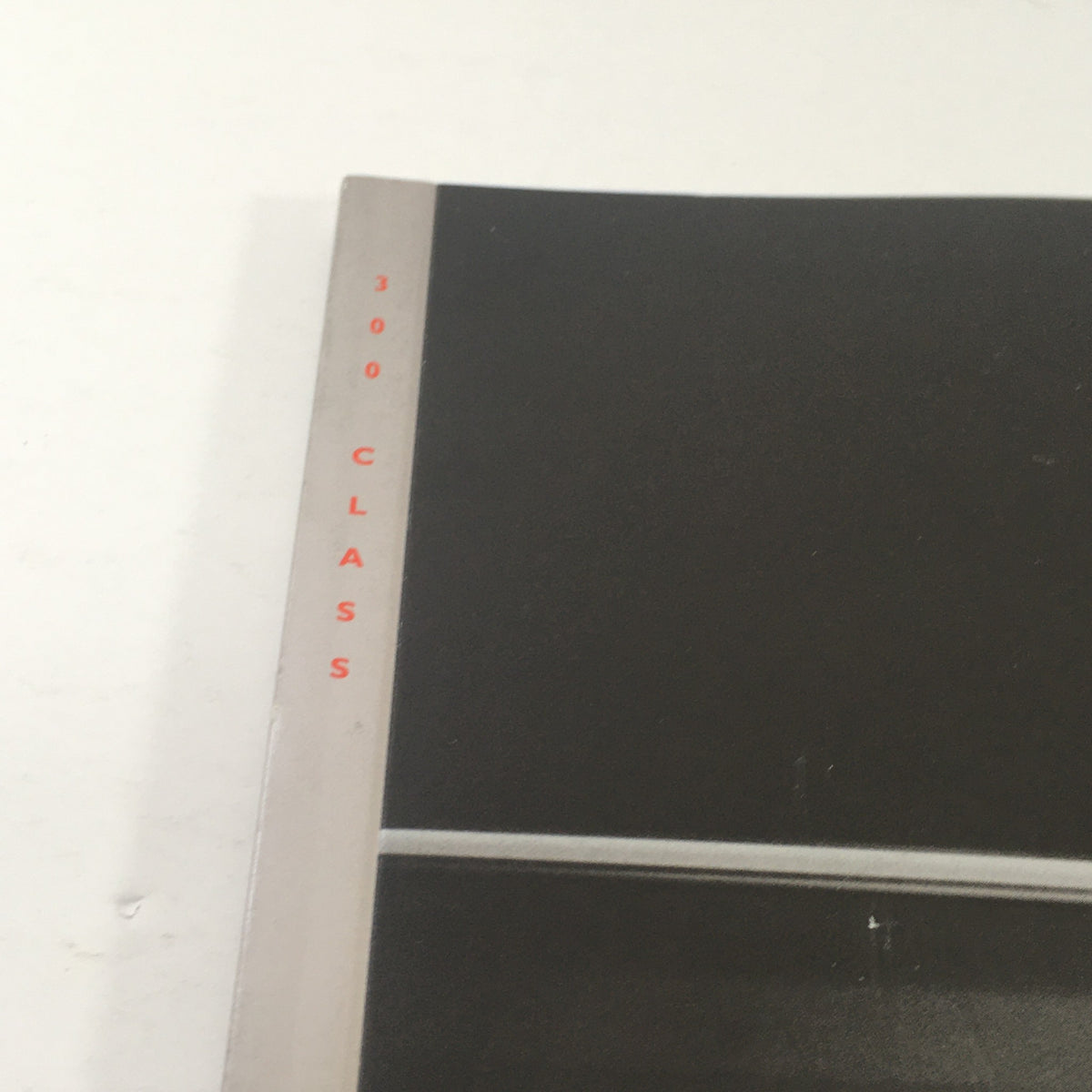 Close-up view of the spine of the 1992 Mercedes-Benz 300-Class Dealership Car Auto Brochure Catalog displaying '300 CLASS' label.