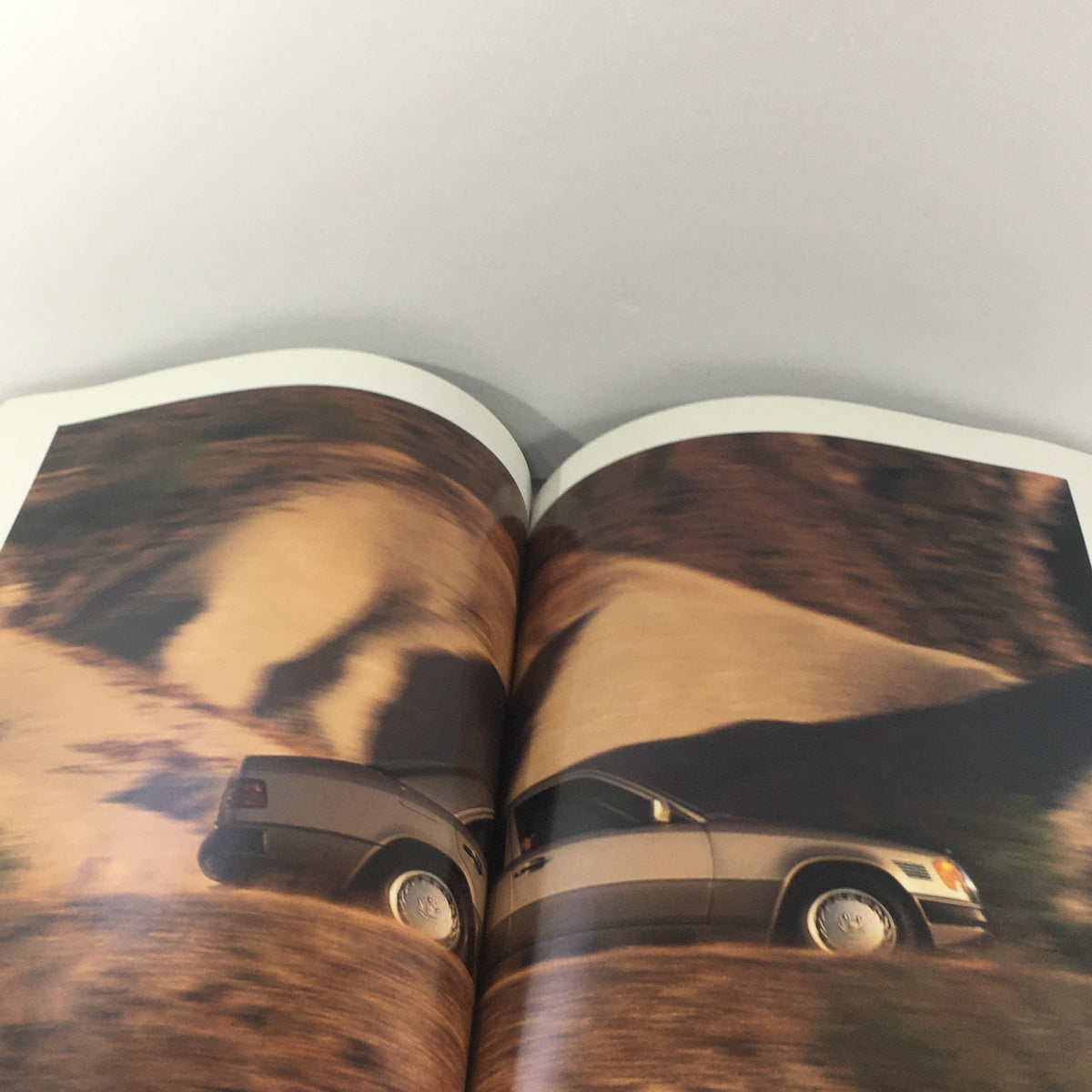 Interior view of the 1992 Mercedes-Benz 300-Class Dealership Car Auto Brochure Catalog, showcasing a scenic background with a partially visible car.