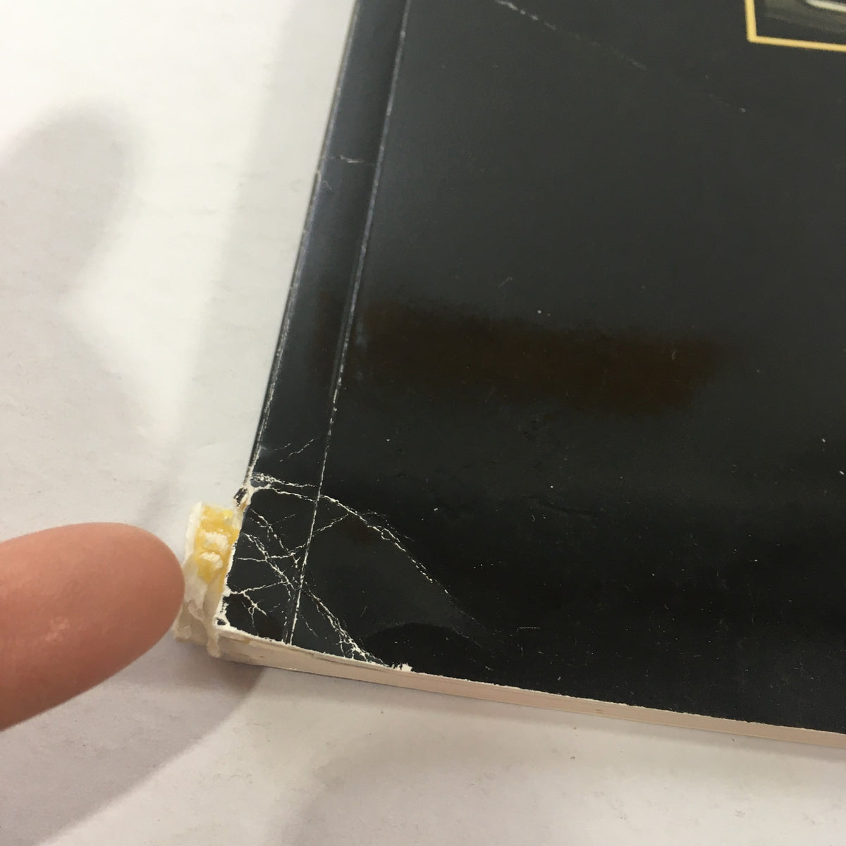 Detailed view of the corner of the 1984 Mercedes-Benz 190E 2.3/190D 2.2 Sedans Dealership Car Auto Brochure showing minor wear.