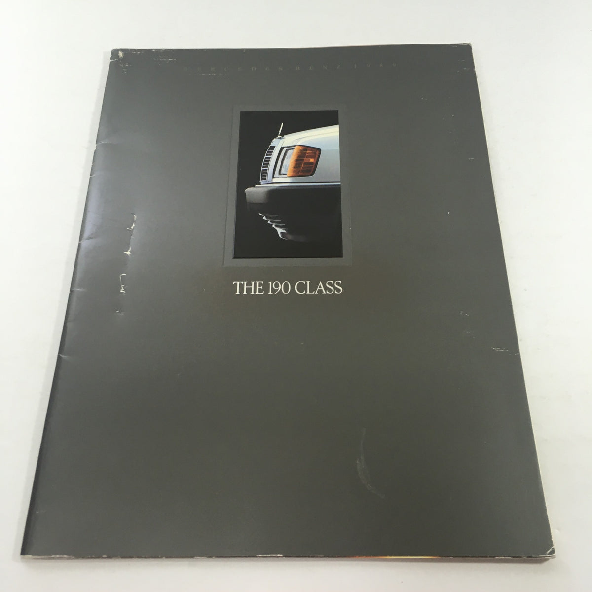 Cover of the 1989 Mercedes-Benz 190-Class 190E 2.6 Sedan Dealership Car Auto Brochure Catalog featuring the front grille and headlight design in a minimalist layout.
