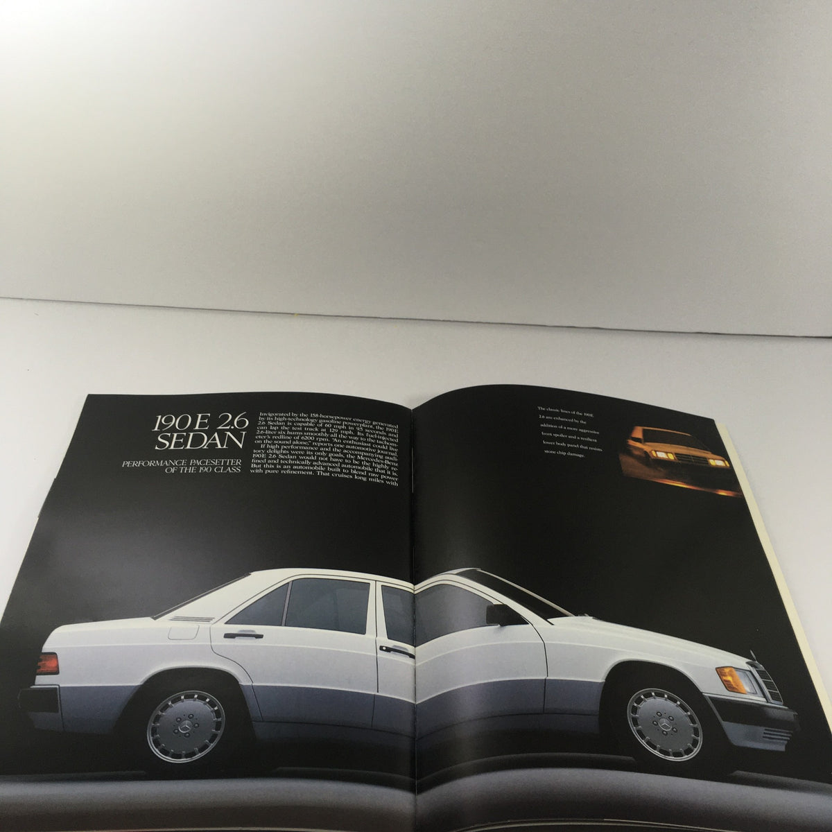 1989 Mercedes-Benz 190-Class 190E 2.6 Sedan Dealership Car Auto Brochure Catalog displaying the 190E 2.6 sedan with detailed descriptions of its performance features.