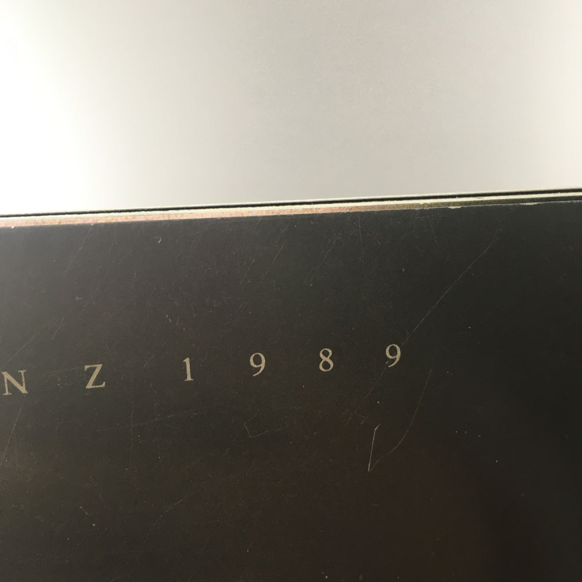 Close-up of the spine of the 1989 Mercedes-Benz 190-Class Sedan Dealership Car Auto Brochure Catalog showing the embossed text 'MERCEDES-BENZ 1989'.