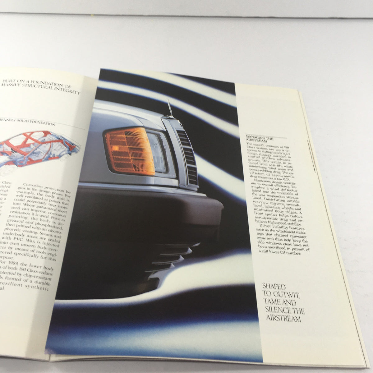 1989 Mercedes-Benz 190-Class Sedan Dealership Car Auto Brochure showcasing the front detail of the vehicle along with text about its structural design.