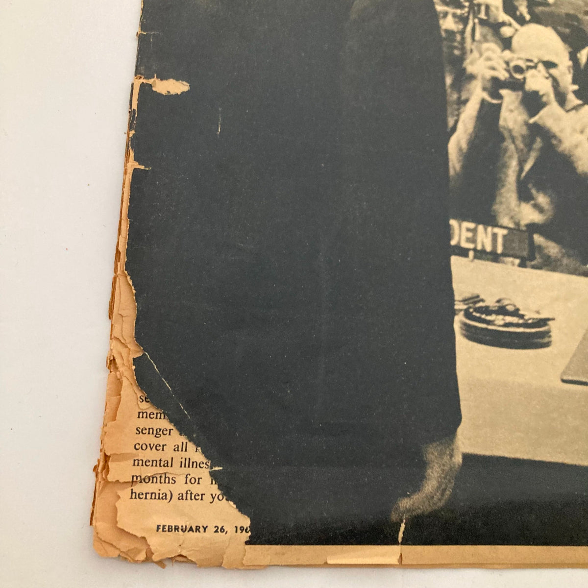 Close-up of the edge of The New York Times Magazine from February 26, 1961, showing wear and tear but maintaining historical significance, featuring Adlai Stevenson and Dag Hammarskjöld.