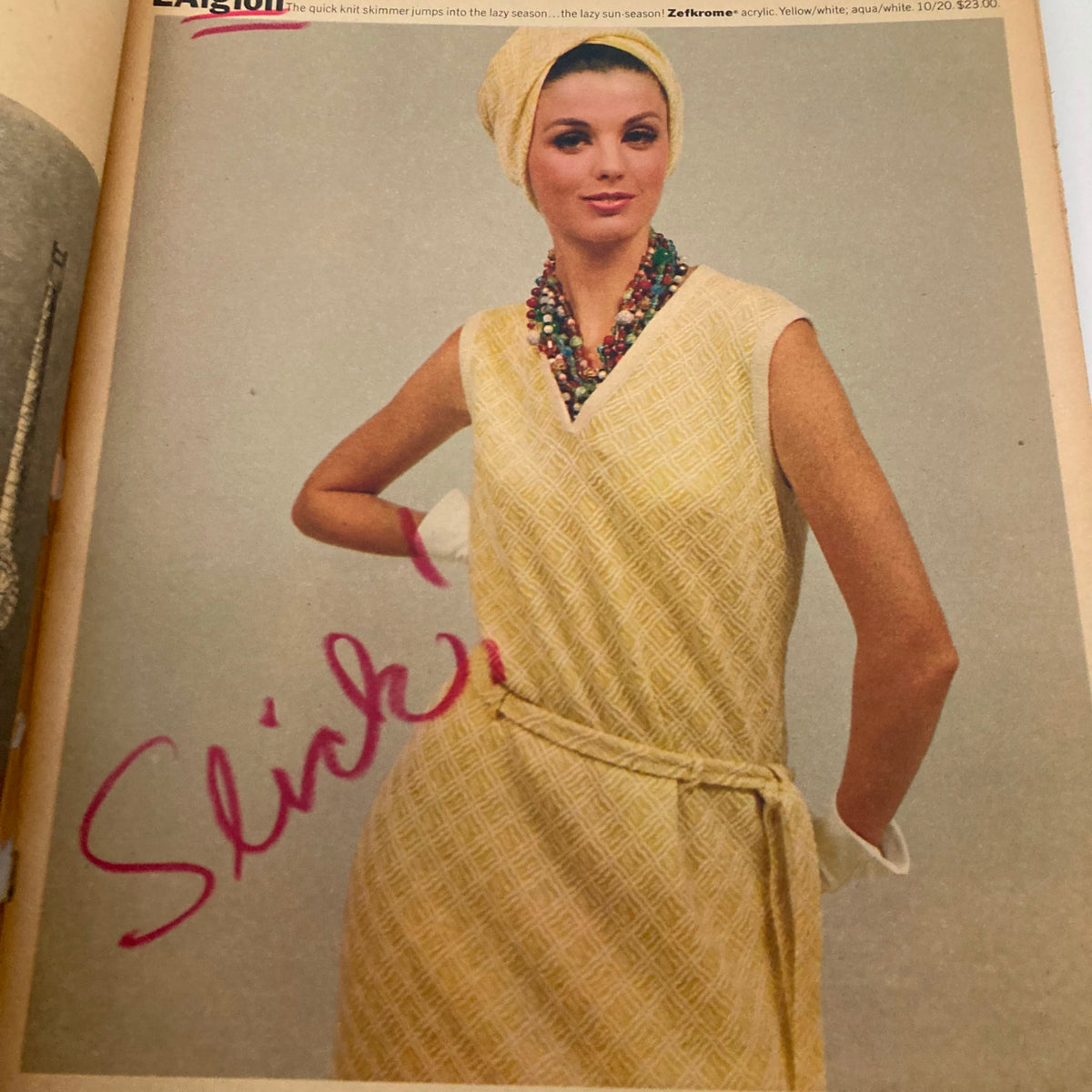 Vintage advertisement from The New York Times Magazine November 24 1963 featuring a model in a stylish yellow dress, accessorized with colorful beads and a head wrap.
