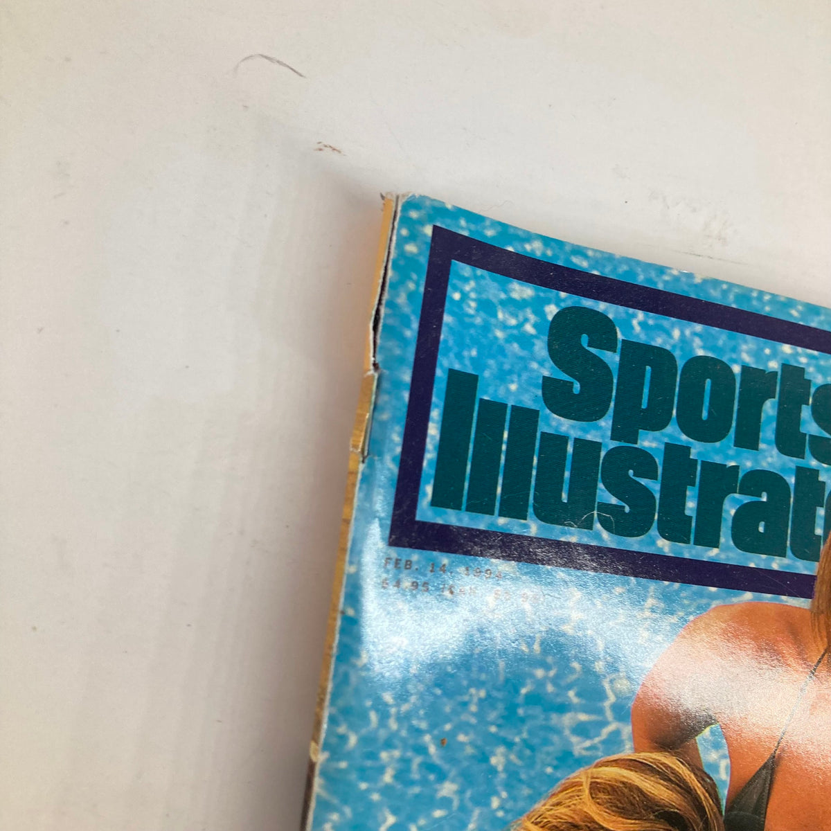 Close-up view of the Sports Illustrated Magazine February 14 1994 cover highlighting the logo and date, featuring Kathy Ireland, Elle Macpherson, and Rachel Hunter.