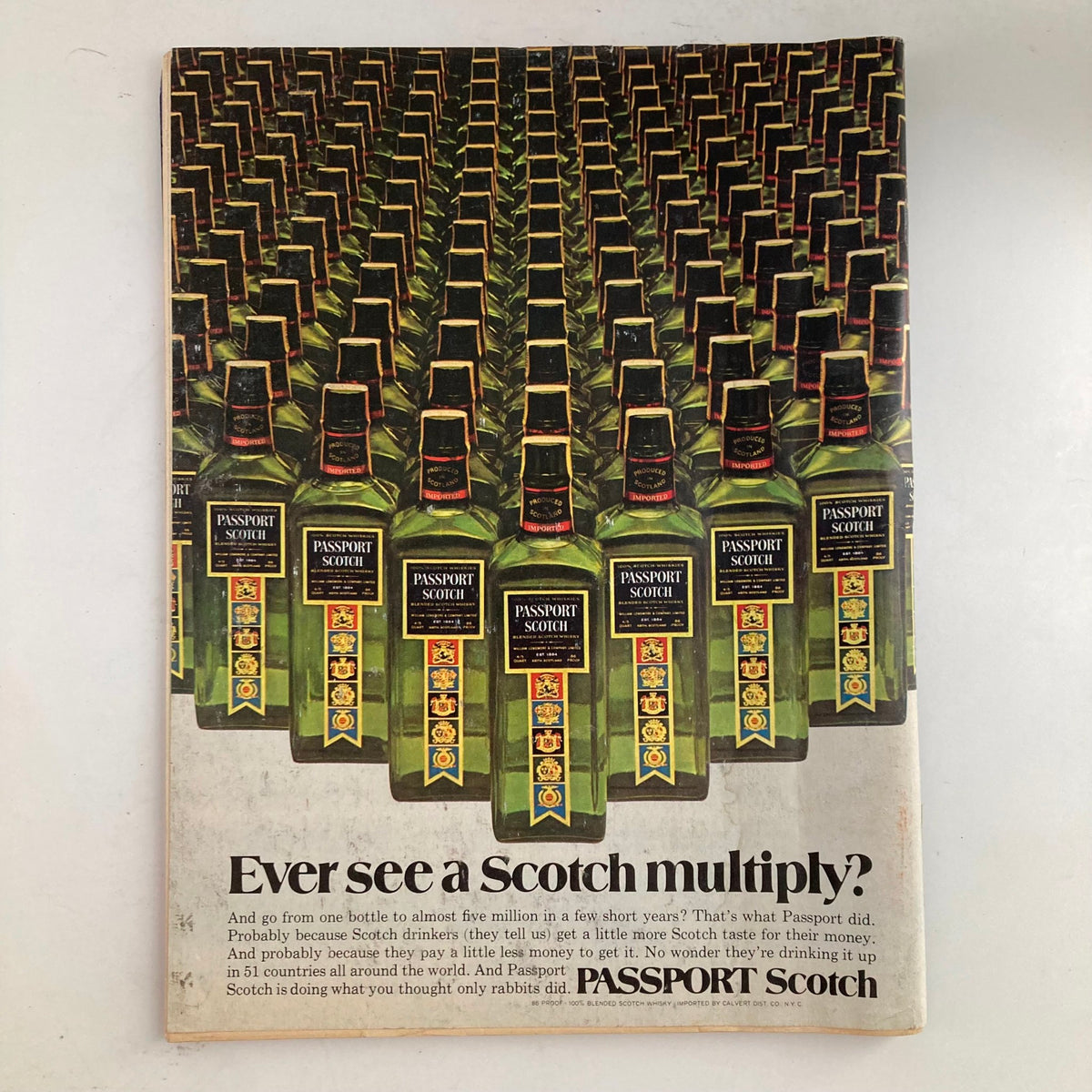 Advertisement page from VTG Newsweek Magazine May 21 1973 showcasing Passport Scotch with a visual of numerous bottles.