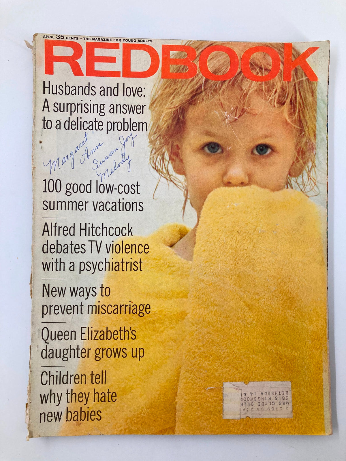 Vintage Redbook Magazine cover from April featuring a child with a yellow towel, highlighting Alfred Hitchcock's debate on TV violence with a psychiatrist. The cover includes handwritten notes and text about relationships and summer vacations.