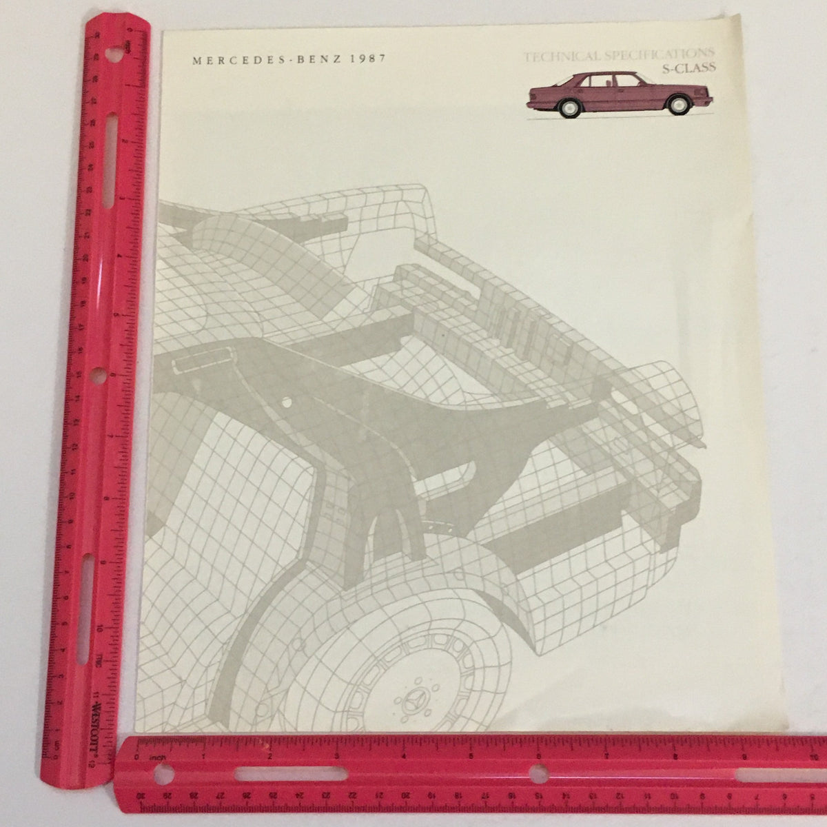 Illustration of the 1987 Mercedes-Benz S-Class chassis, showing a technical drawing with a ruler for scale, from the Dealership Car Auto Brochure Catalog.
