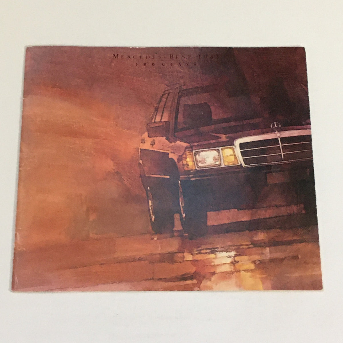 1985 Mercedes-Benz 190-Class Dealership Car Auto Brochure Catalog cover featuring an artistic illustration of the iconic sedan.