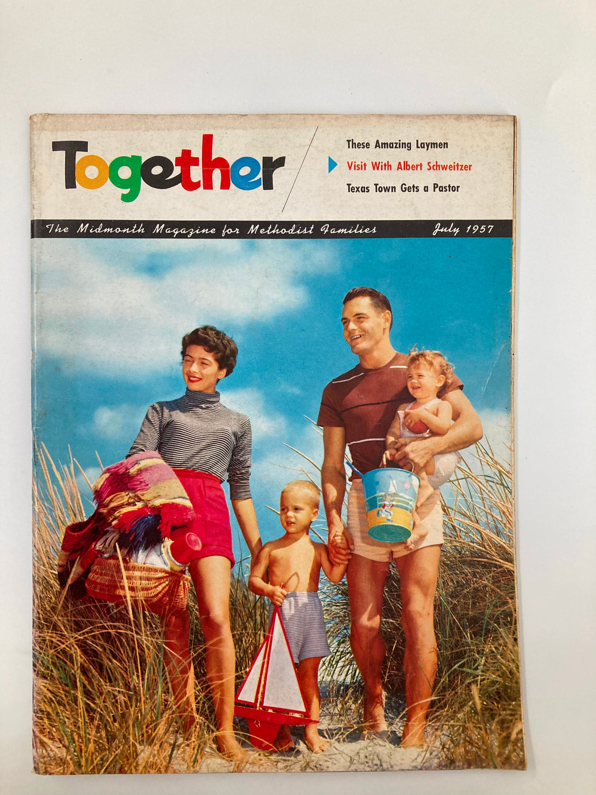 Cover of VTG Together Magazine July 15 1957 depicting a family at the beach, showcasing mid-century family values.
