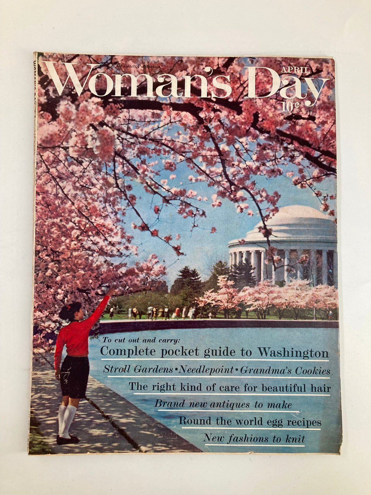 Cover of VTG Woman's Day Magazine April 1962 featuring cherry blossoms and a woman holding a guide to Washington, showcasing the magazine's title and its features.