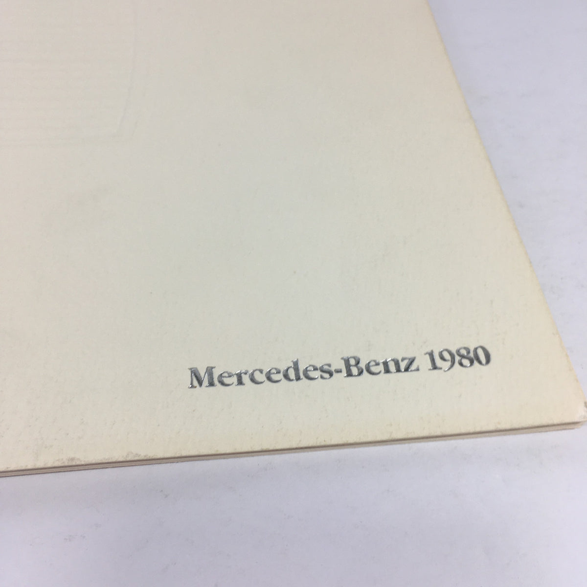Detailed shot of the back cover of the 1980 Mercedes-Benz 280CE dealership car brochure catalog, focusing on the 'Mercedes-Benz 1980' marking.